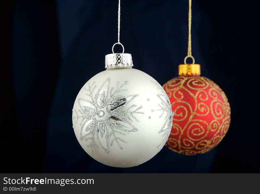 Red and silver Christmas decoration isolated on blue/black background. Red and silver Christmas decoration isolated on blue/black background