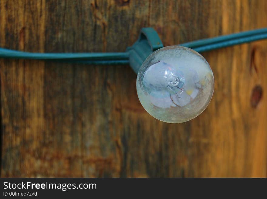 Light bulb attached to a wooden post