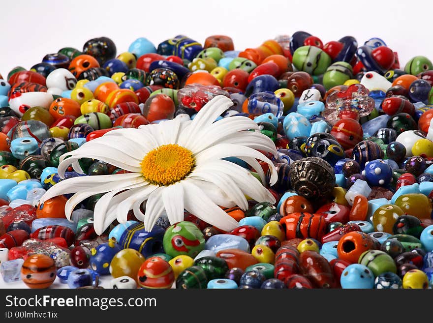 Colorful beads and big daisy flower. Colorful beads and big daisy flower