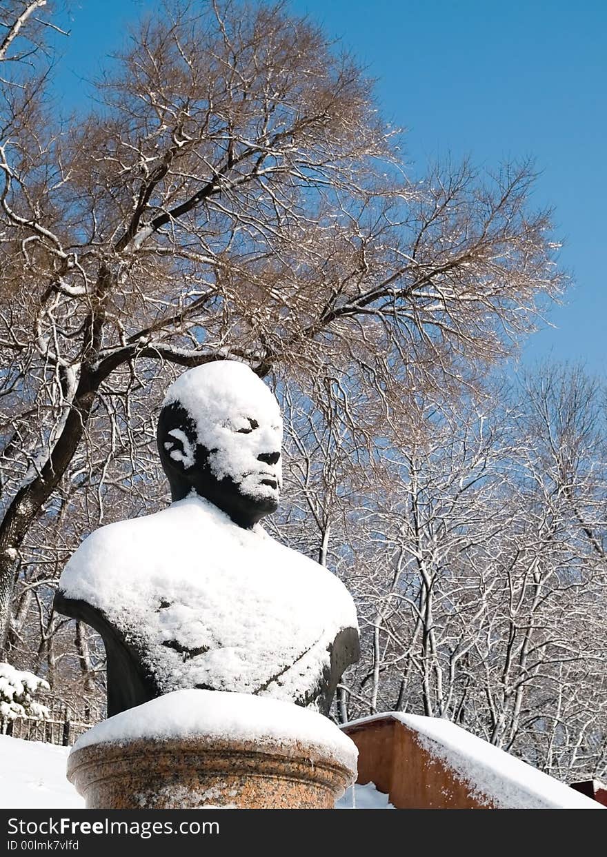 Snow statue of russian admiral kuznetsov in vladivostok town park. Winter seasonal view with snow trees and blue sky. Snow statue of russian admiral kuznetsov in vladivostok town park. Winter seasonal view with snow trees and blue sky.