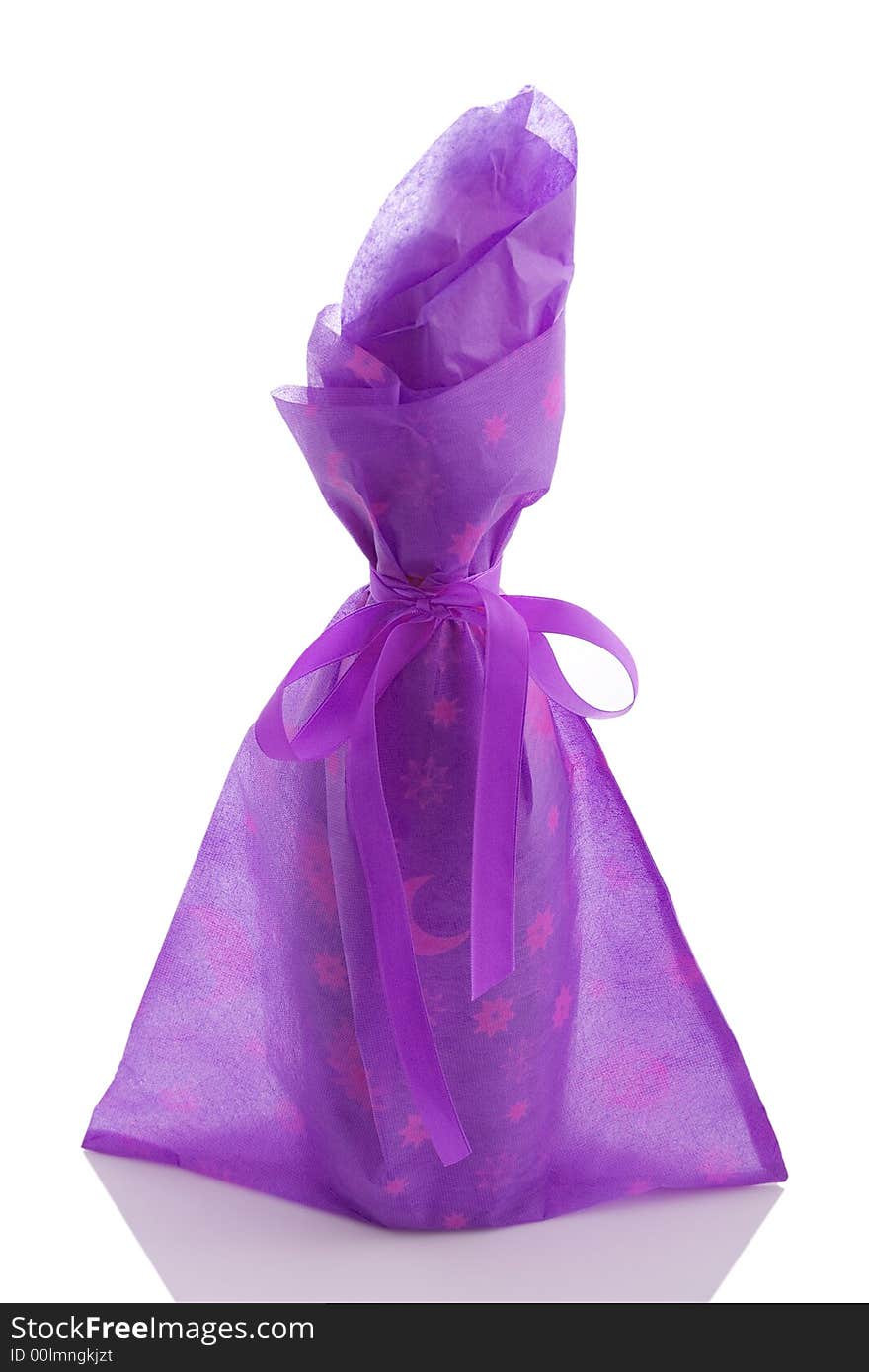 A gift wrapped wine bottle over a white background