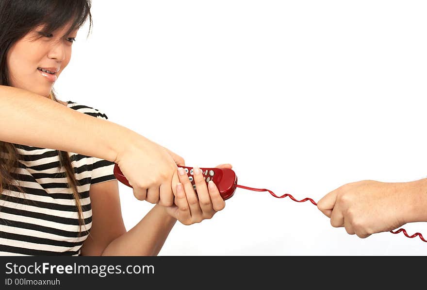 A  woman pulling the handset of a red phone. A  woman pulling the handset of a red phone