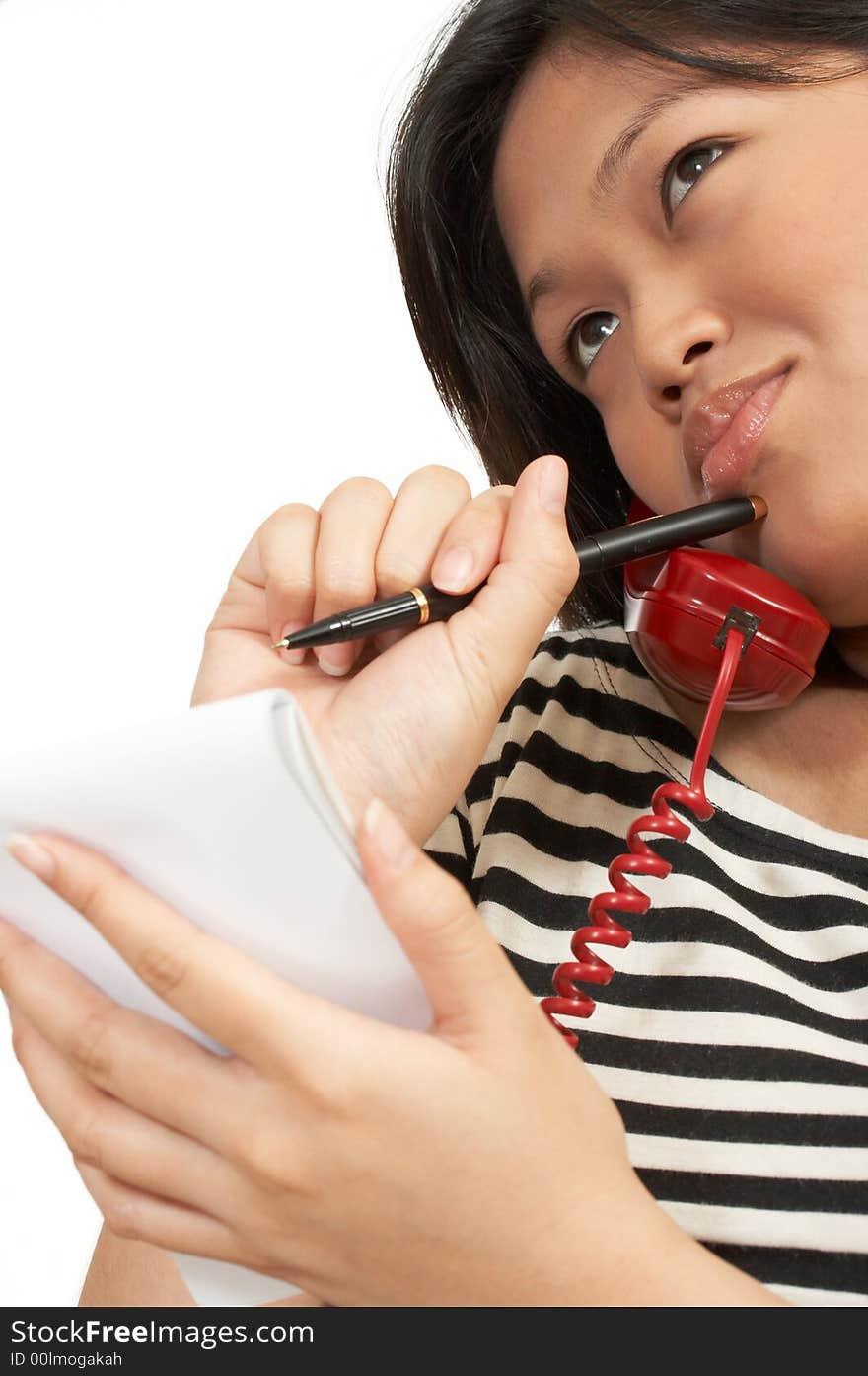 A woman with a notepad making a call on the phone. A woman with a notepad making a call on the phone