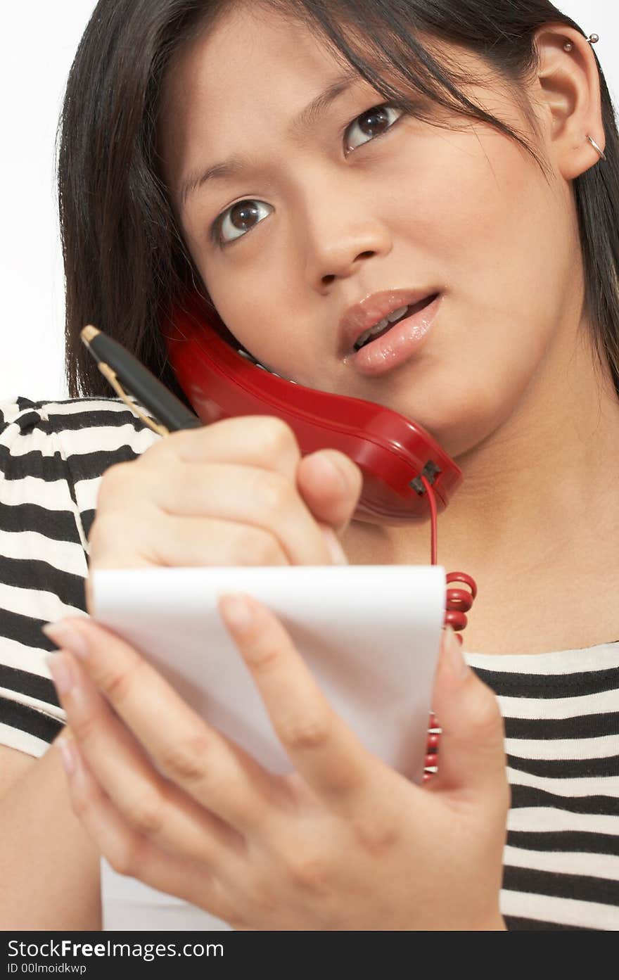 A woman with a notepad making a call on the phone. A woman with a notepad making a call on the phone