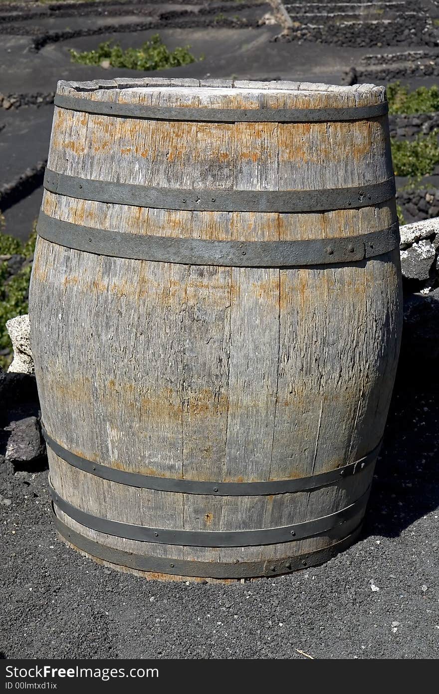 Old wine barrel in a vineyard in Lanzarote, Canary Islands. Old wine barrel in a vineyard in Lanzarote, Canary Islands