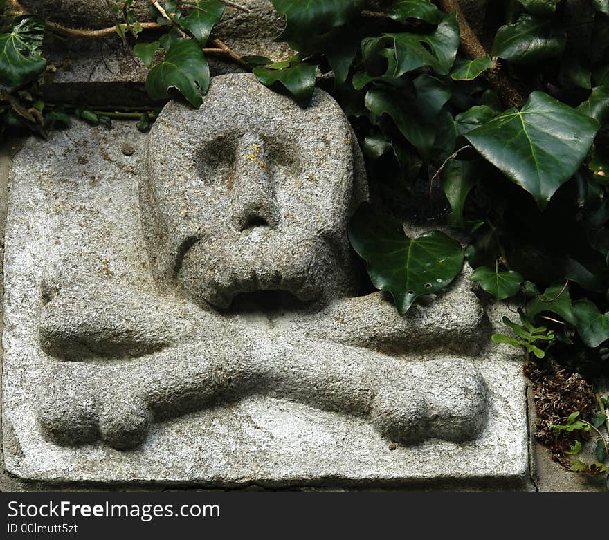 A tombstone with a scull and crossed bones. A tombstone with a scull and crossed bones