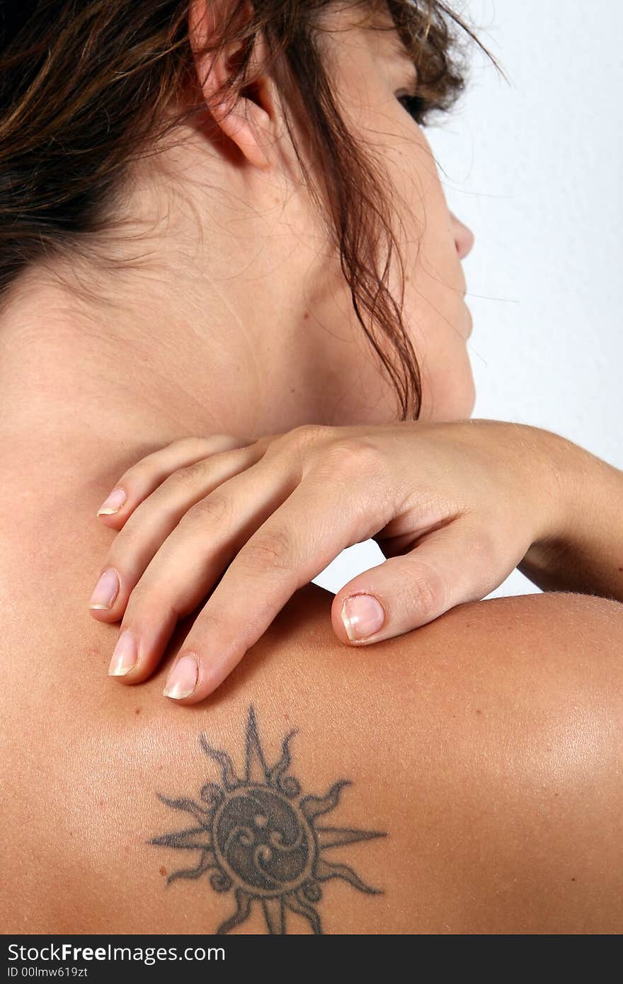 A young woman screams in pain and holds her shoulder. A young woman screams in pain and holds her shoulder.