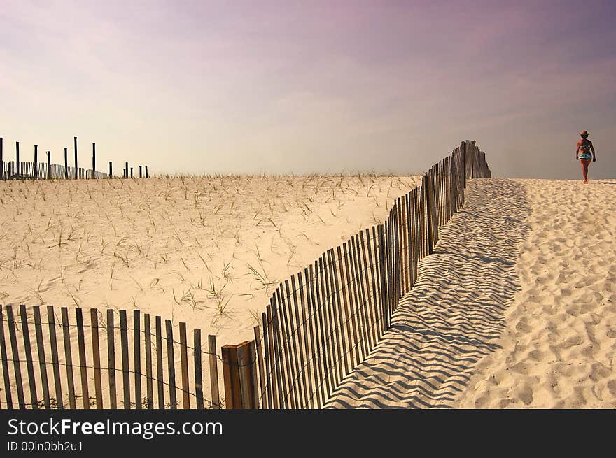 A woman walking down to Navarre Beach, Florida. A woman walking down to Navarre Beach, Florida.