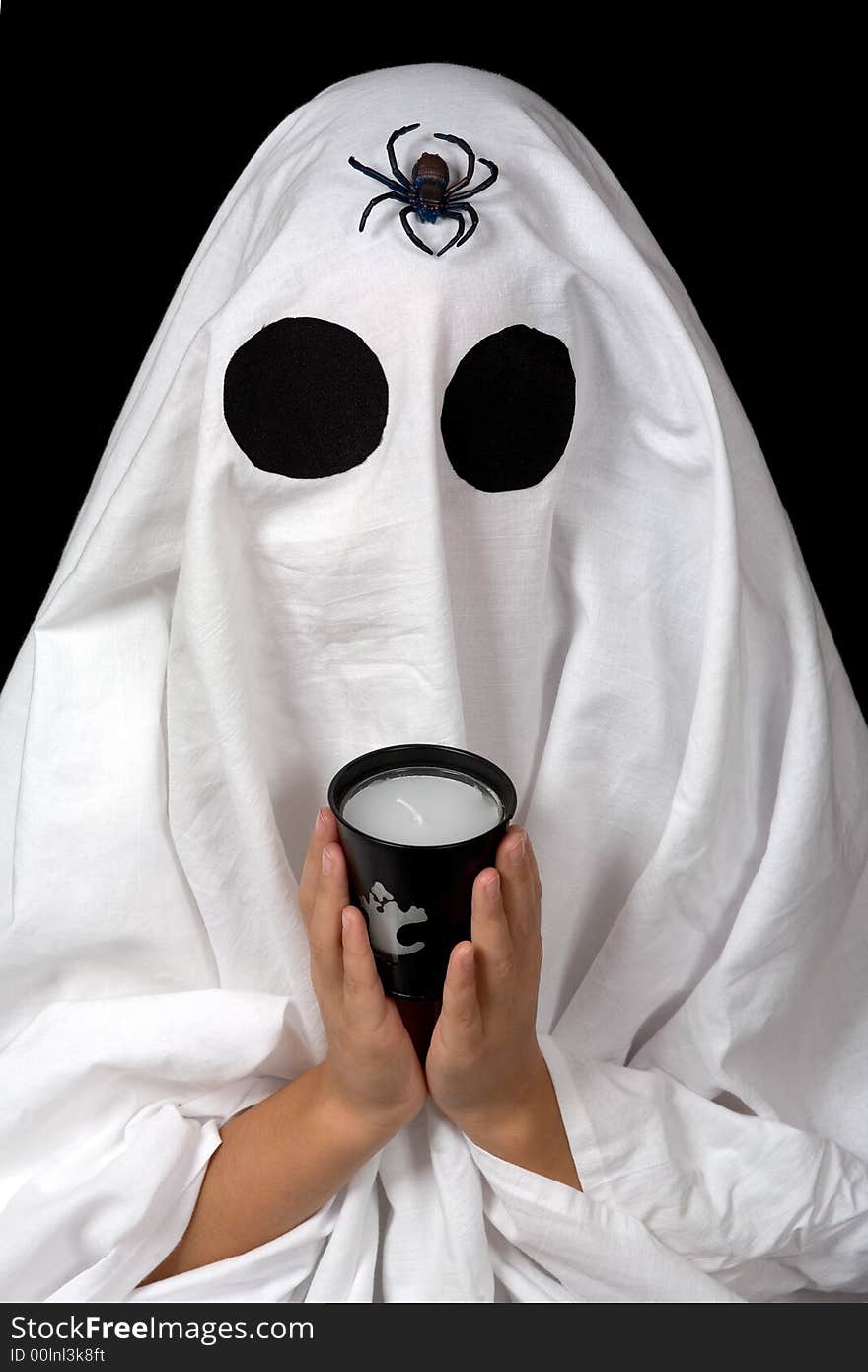 Ghost child hold an halloween candle and a spider climb on her head. Ghost child hold an halloween candle and a spider climb on her head