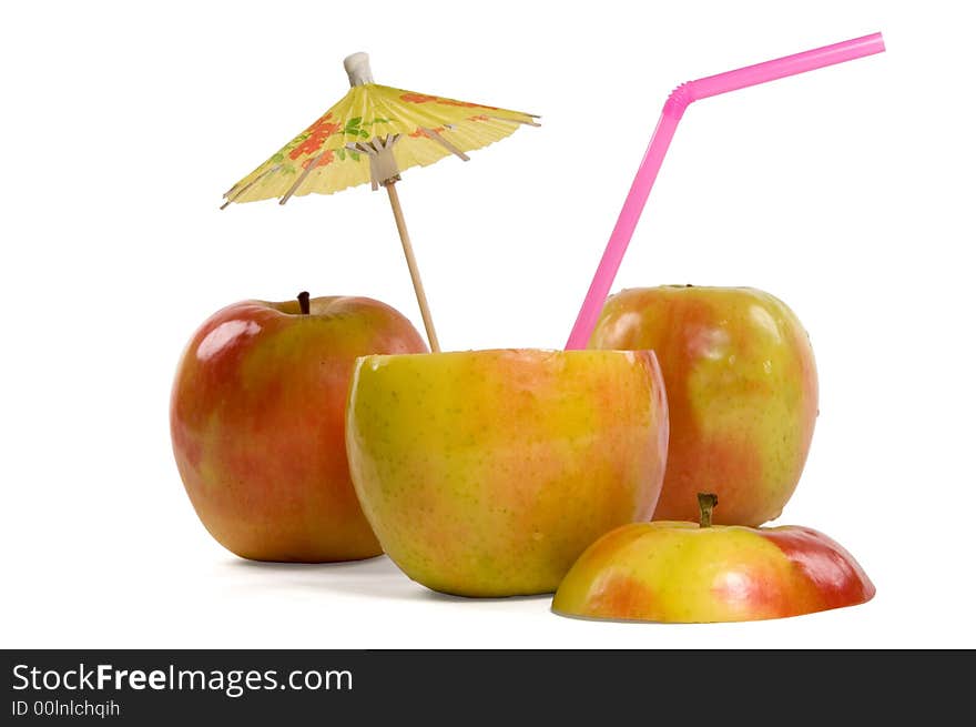 Apples with umbrella and straw on white background