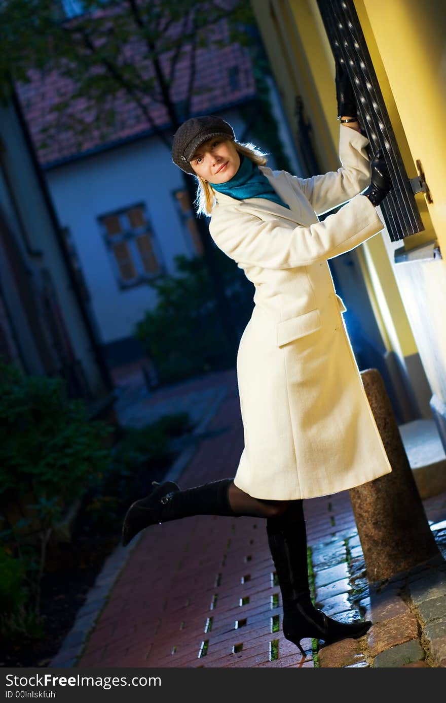 Beautiful blond girl in european old city at night time. Beautiful blond girl in european old city at night time