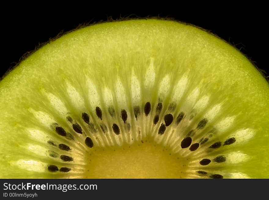 Half kiwi slice isolated on black