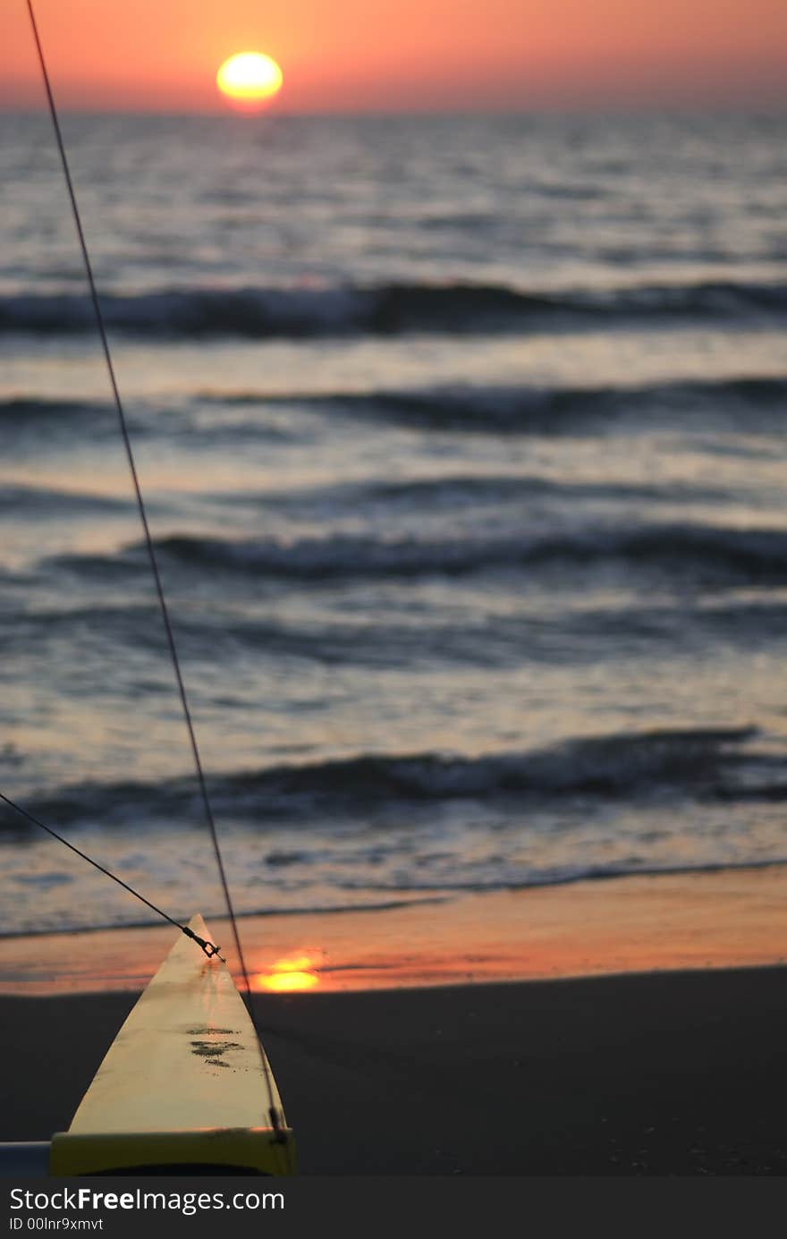 A couple sit in the beach  watching the sunset. A couple sit in the beach  watching the sunset