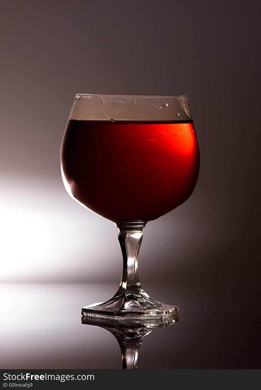 Tall vine glass full of red vine.