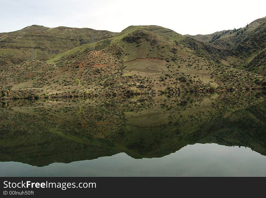 Calm river displaying a perfect reflection