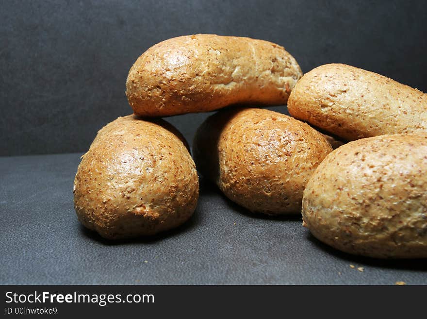 Fresh bread buns on grey tiles. Fresh bread buns on grey tiles