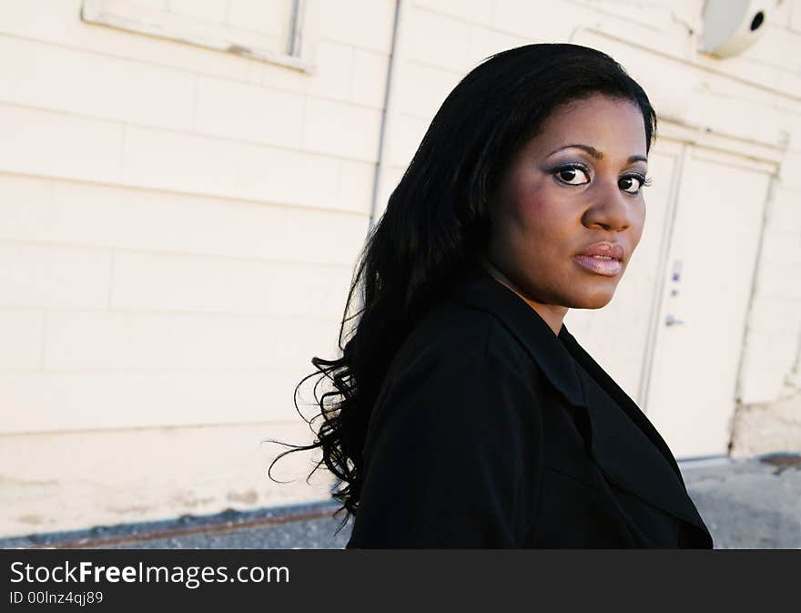 African America business woman in front of an industrial building. African America business woman in front of an industrial building.