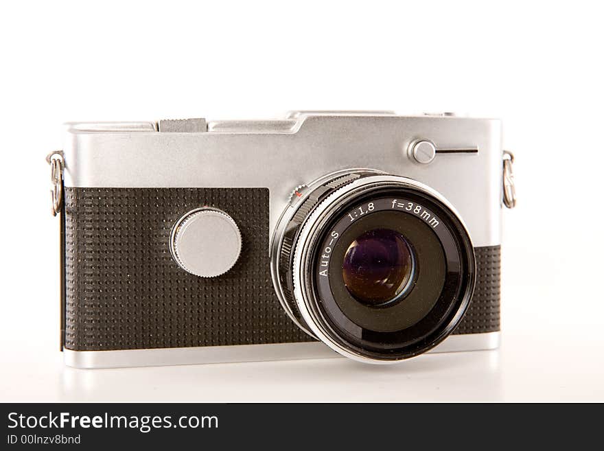 A silver and black retro point-and-shoot camera isolated on white. A silver and black retro point-and-shoot camera isolated on white.