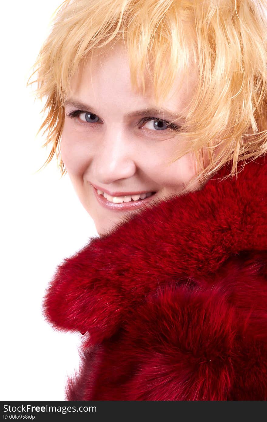 The beautiful blonde in a red fur coat. A portrait, studio shooting. The beautiful blonde in a red fur coat. A portrait, studio shooting