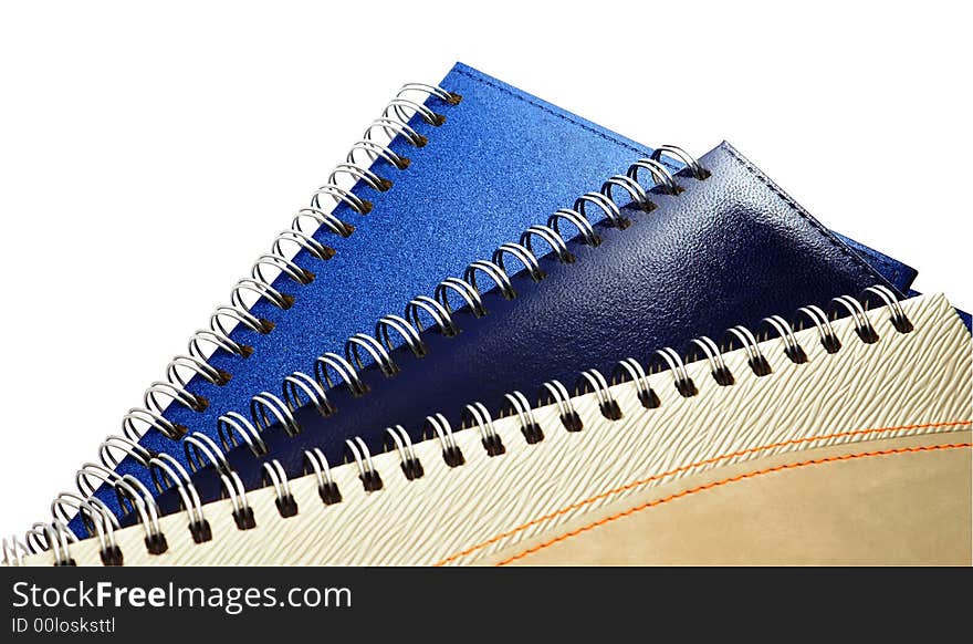 Three business of a writing-book with spiral fastening on a white background. Three business of a writing-book with spiral fastening on a white background.