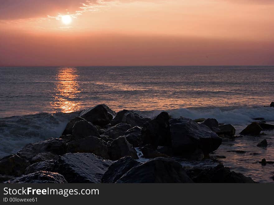 Rocks and blue sea at sunset