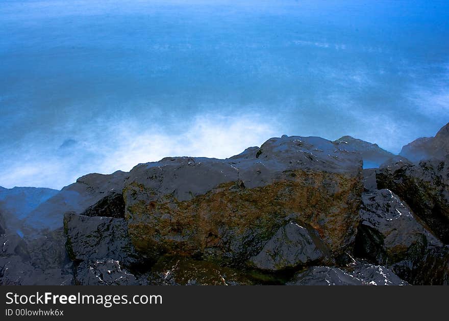 Rocks and blue sea at sunset