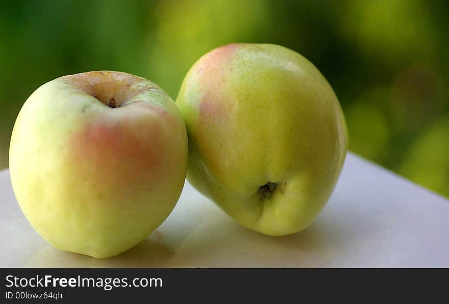 Closeup of green apples on green background.