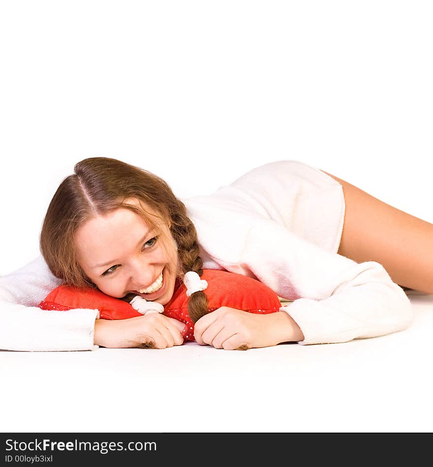 Beautiful girl lays on white background and smiles. Beautiful girl lays on white background and smiles