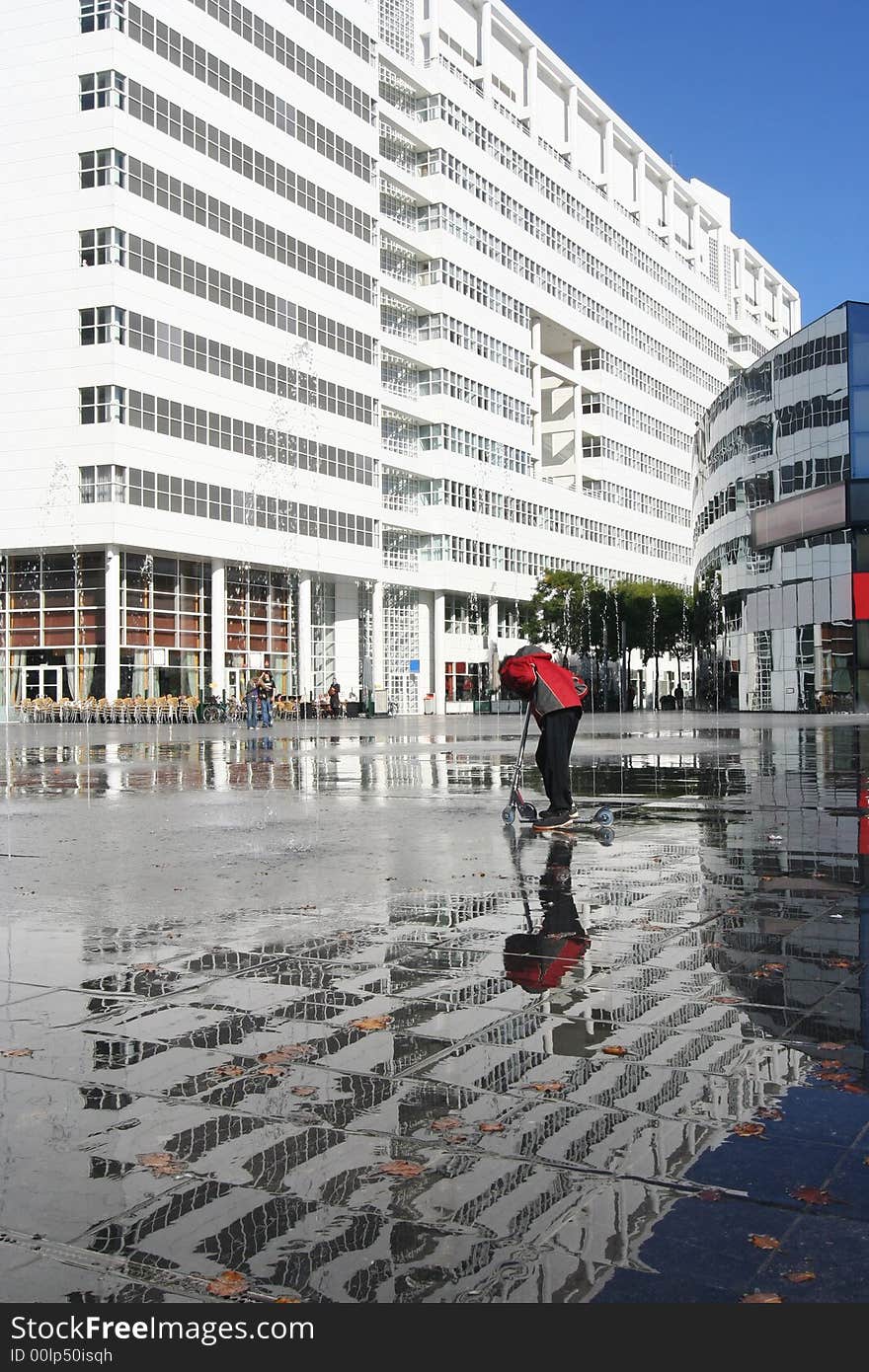 City Hall of The Hague, Holland, with child on kick scooter