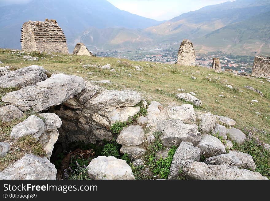 Ruins of ancient settlement in the Caucasus mountains (tombs and sarcophagus)