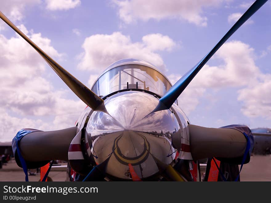 An old prop plane against a blue sky.