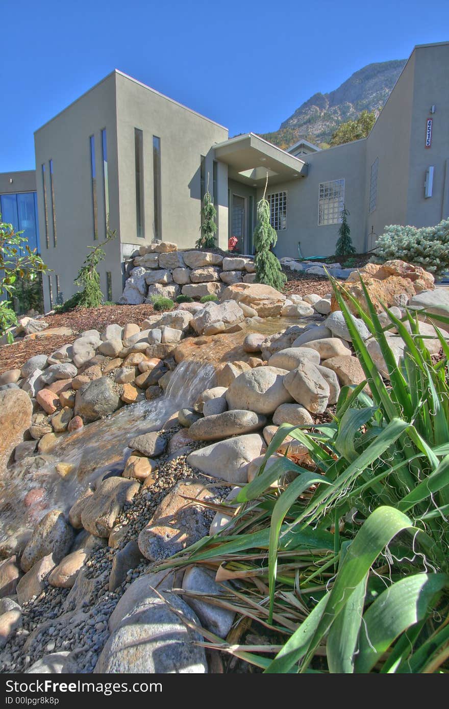 A small section of the front yard with beautiful creek water feature xeriscape landscaping. A small section of the front yard with beautiful creek water feature xeriscape landscaping