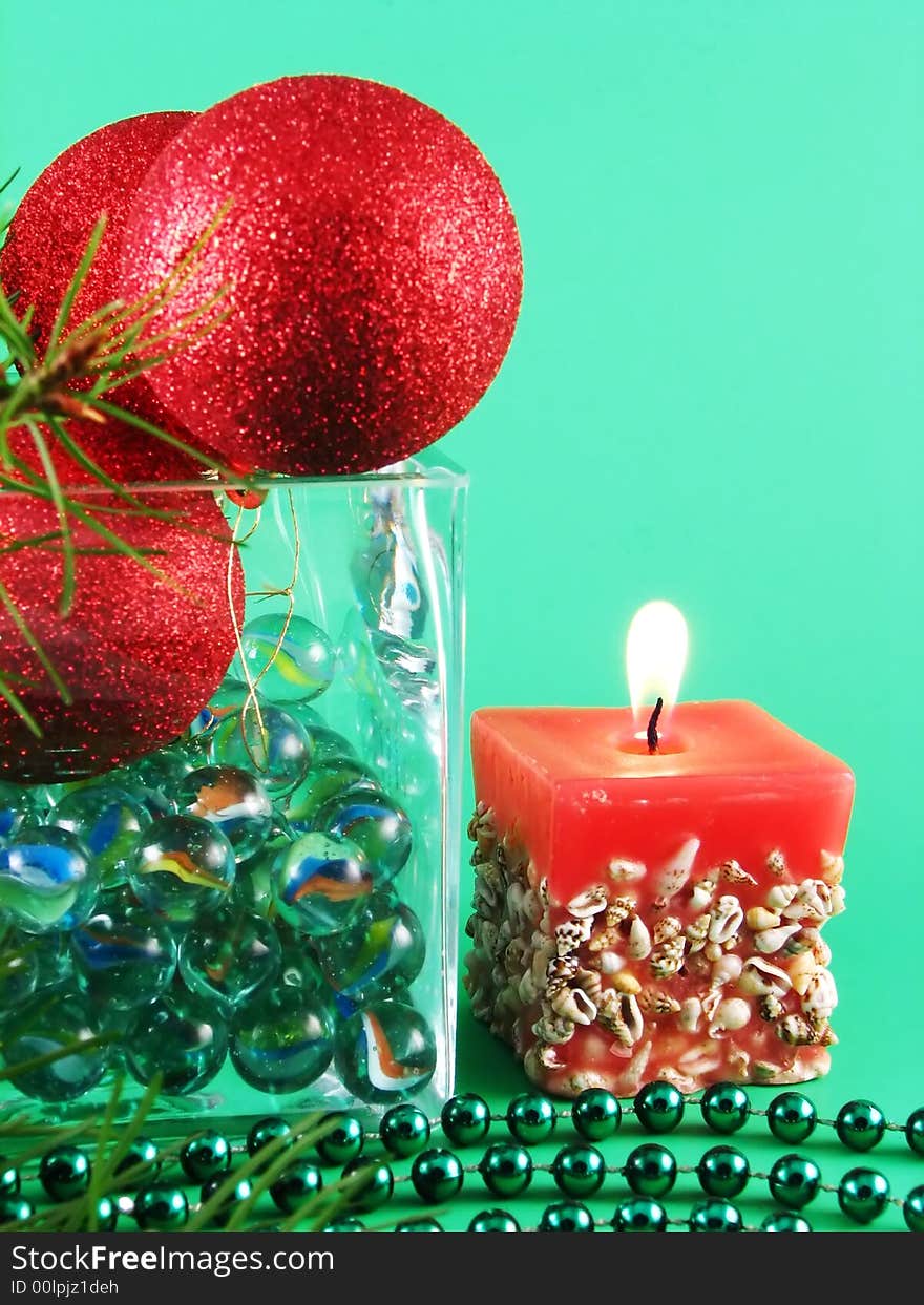 Image from christmas series: meny glass balls and candle on green background. Image from christmas series: meny glass balls and candle on green background