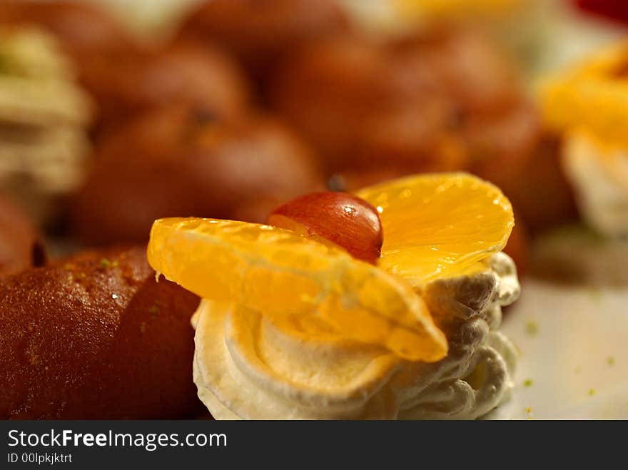 Wedding cake with orange and cream - all in front of an oriental, romantic background. Wedding cake with orange and cream - all in front of an oriental, romantic background