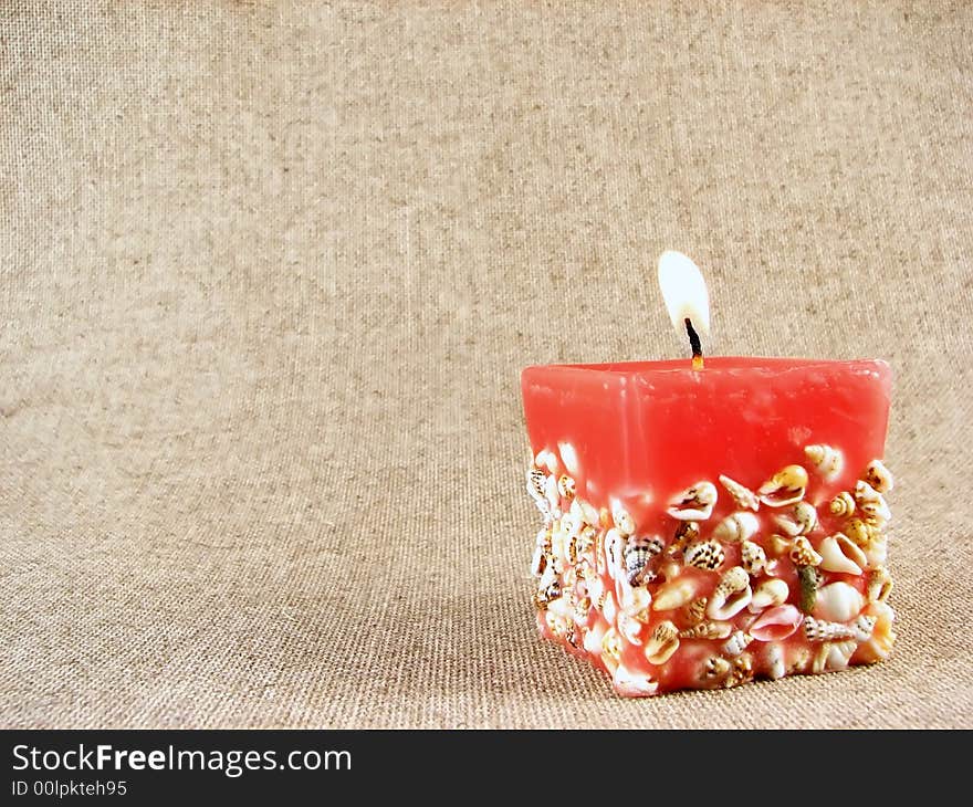 Home series: red candle on beige tissue