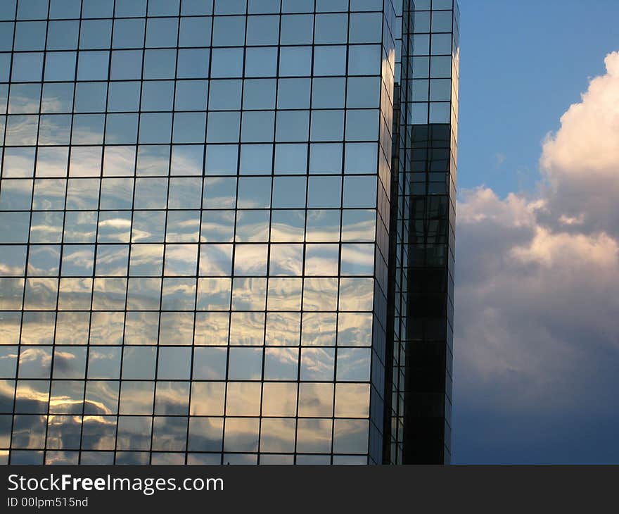 Building under lowering clouds, by a summer afternoon.