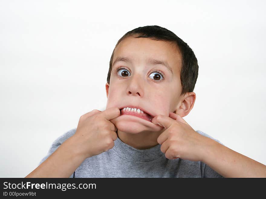 A young boy making a scary face