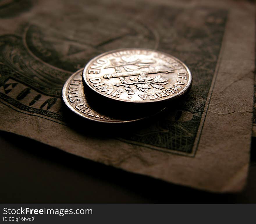 This is a closeup of two dimes tails up on a dollar bill. This is a closeup of two dimes tails up on a dollar bill.