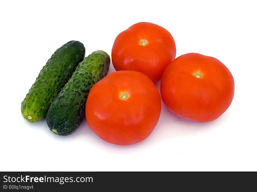 Cucumbers and tomato, isolated on white background