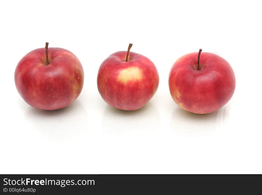 Three red apples on a white background