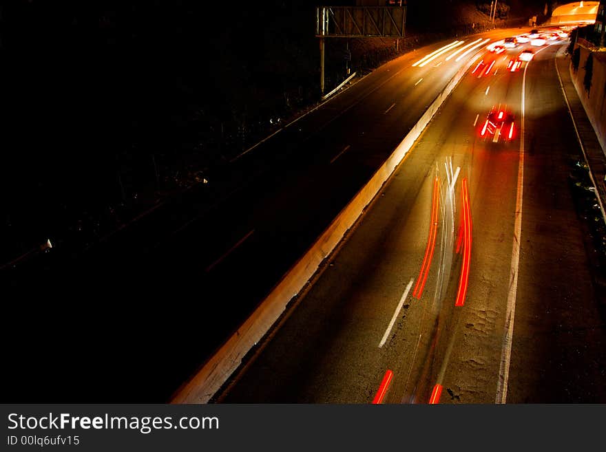 Busy freeway with streaks of lights from the headlights and tail lights of the cars. Busy freeway with streaks of lights from the headlights and tail lights of the cars