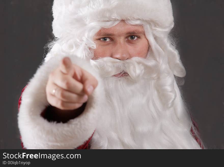 An inage of Santa Claus showing his forefinger. An inage of Santa Claus showing his forefinger