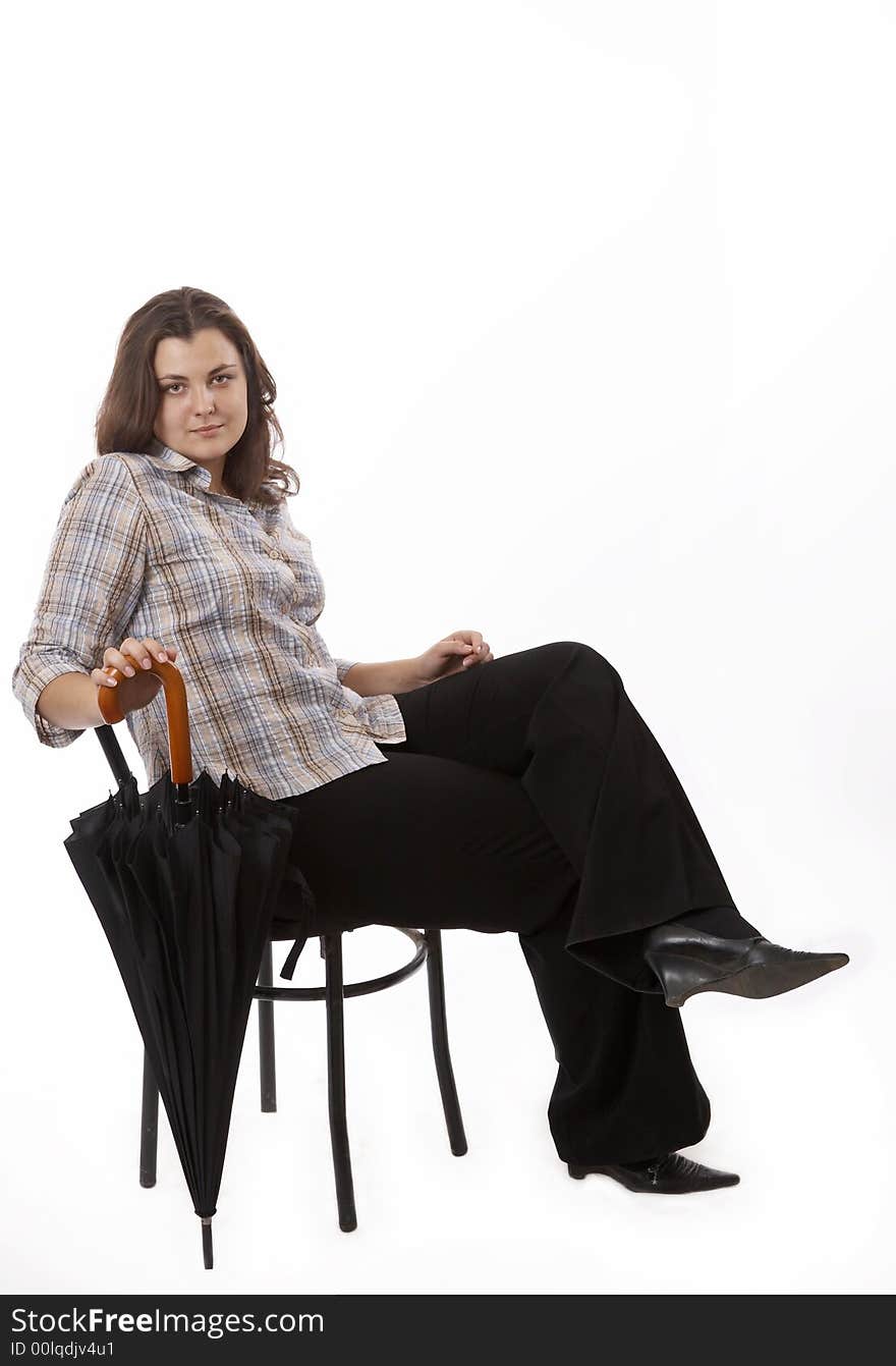 Young woman isolated on white with umbrella sitting on a chair