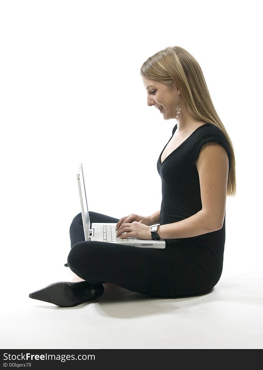 Woman sitting on floor with a white laptop computer. Woman sitting on floor with a white laptop computer.