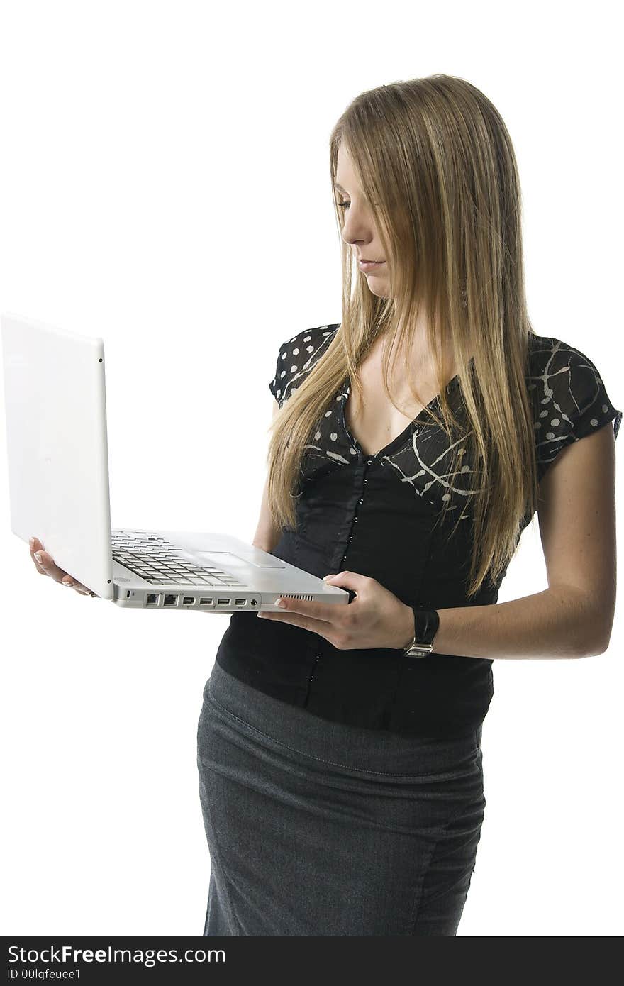 Woman standing with a white laptop computer against a white backdrop. Woman standing with a white laptop computer against a white backdrop.