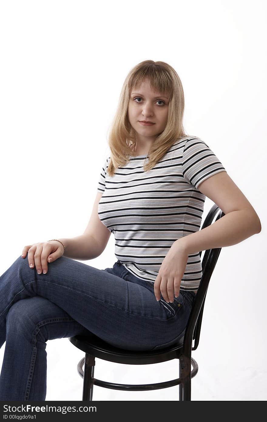 Woman sitting on a chair isolated on white