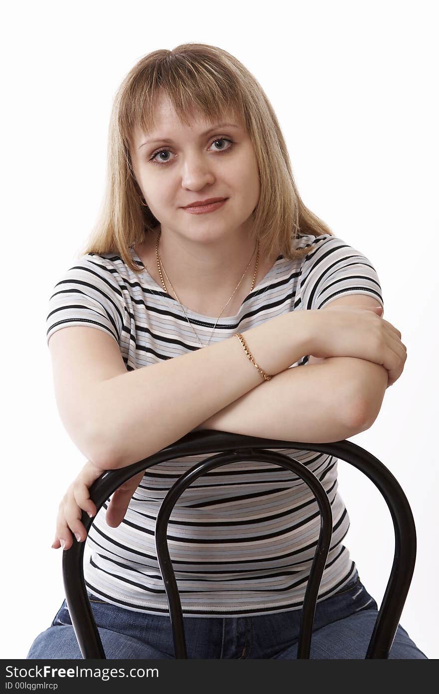 Woman sitting on a chair isolated on white