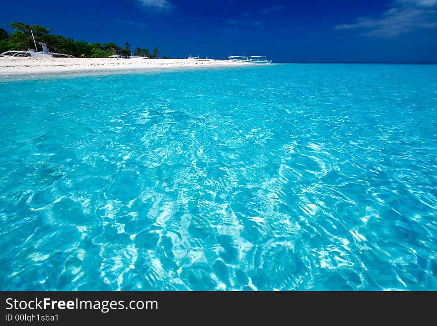 Ocean View of beautiful pacific blue water beside a tropical island with white sand. Ocean View of beautiful pacific blue water beside a tropical island with white sand