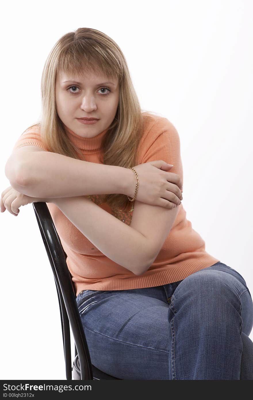 Woman sitting on a chair isolated on white