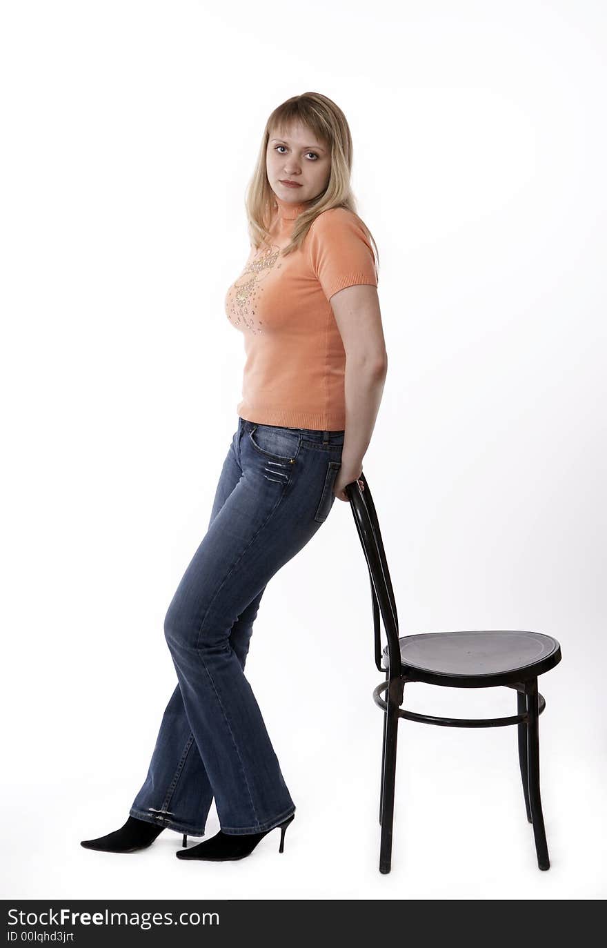 Woman standing by a chair